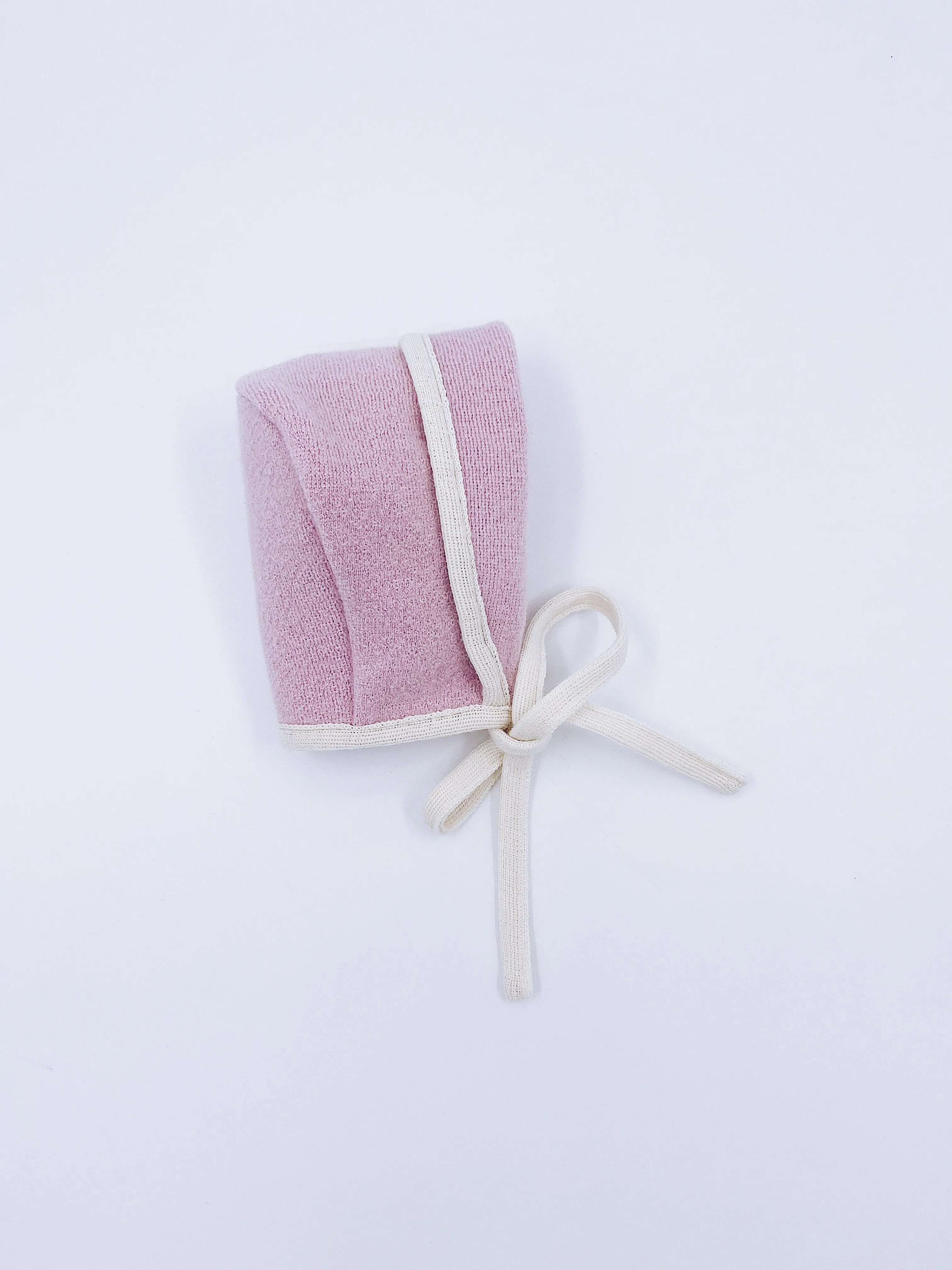 Beautiful pink merino wool bonnet with cream details.
